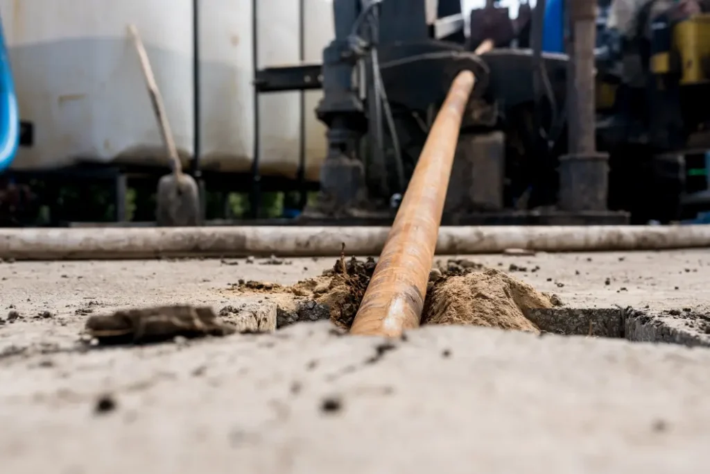 New pipe being pulled through during a Western Chicago horizontal boring job, with the surrounding ground left intact.