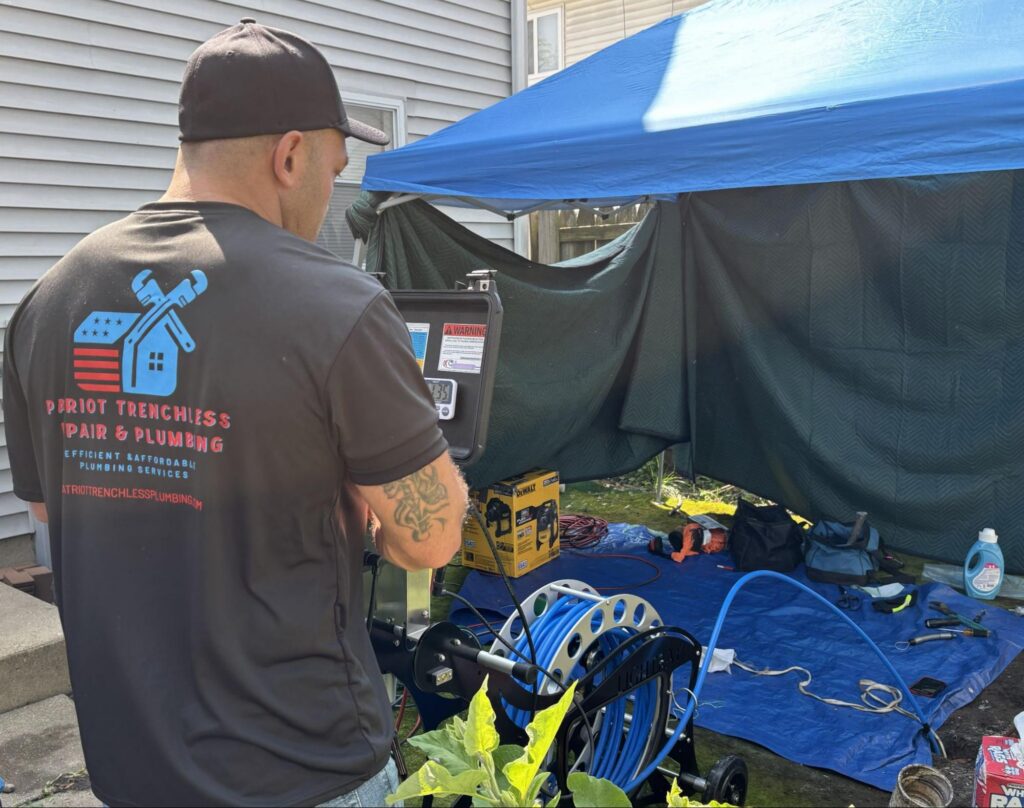 Patriot Trenchless plumber on site performing a trenchless sewer lining job in the Fox Valley