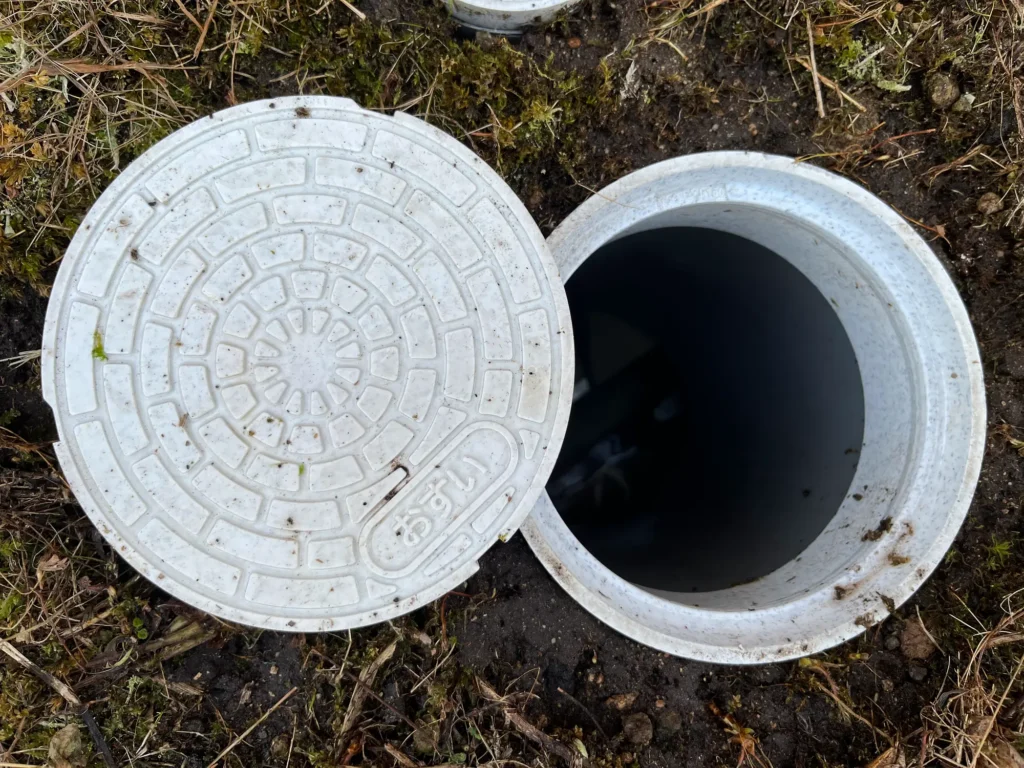 A finished sewer cleanout installation with the cap removed to show main line access