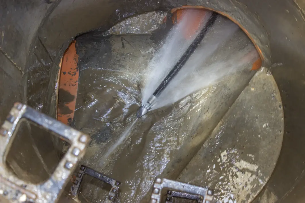 Hydro jetting nozzle blasting pressurized water to clear buildup inside an Illinois sewer pipe.