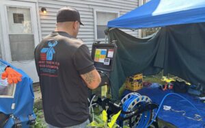 Patriot Trenchless Plumbing technician operating trenchless sewer equipment at an Illinois home