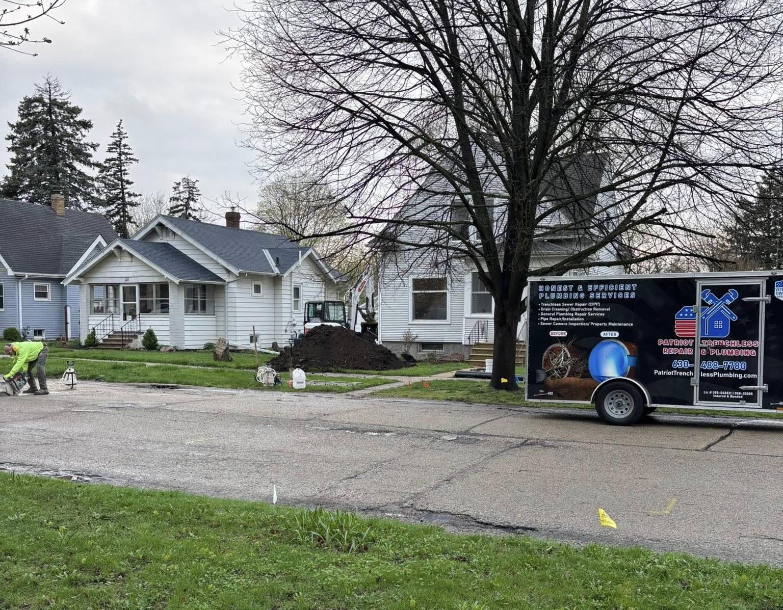 Patriot Trenchless Plumbing opening a small access point for trenchless sewer lining in DeKalb.